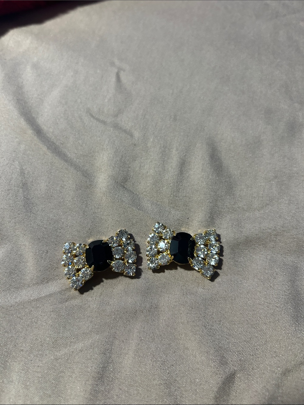 Elegant Black and Gold Bow Brooch Set with Clear Crystals